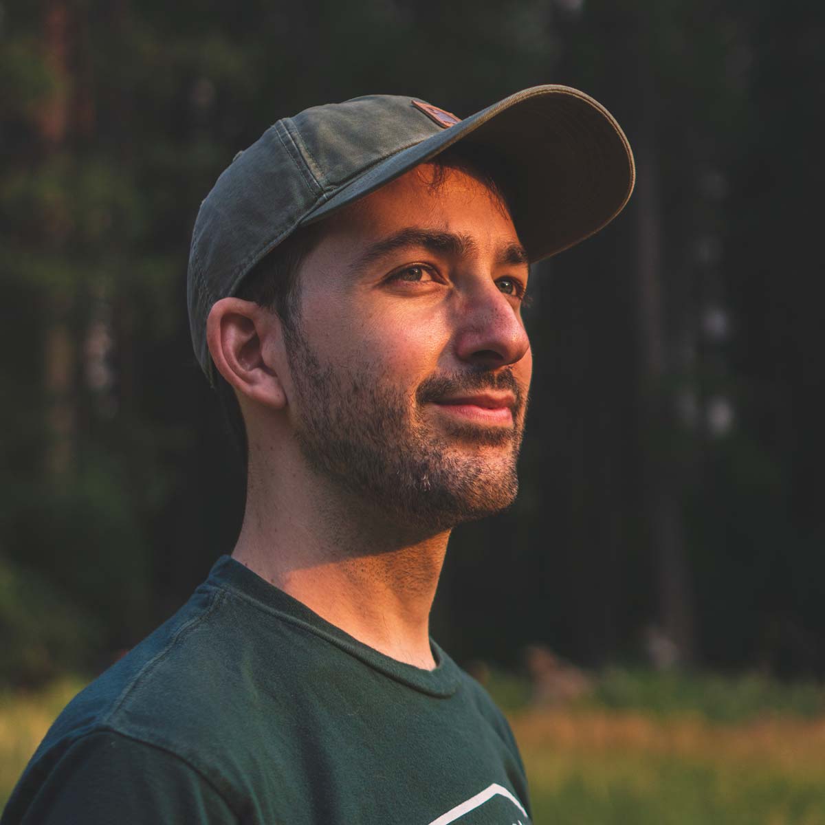 Close up of a man wearing a baseball hat outside