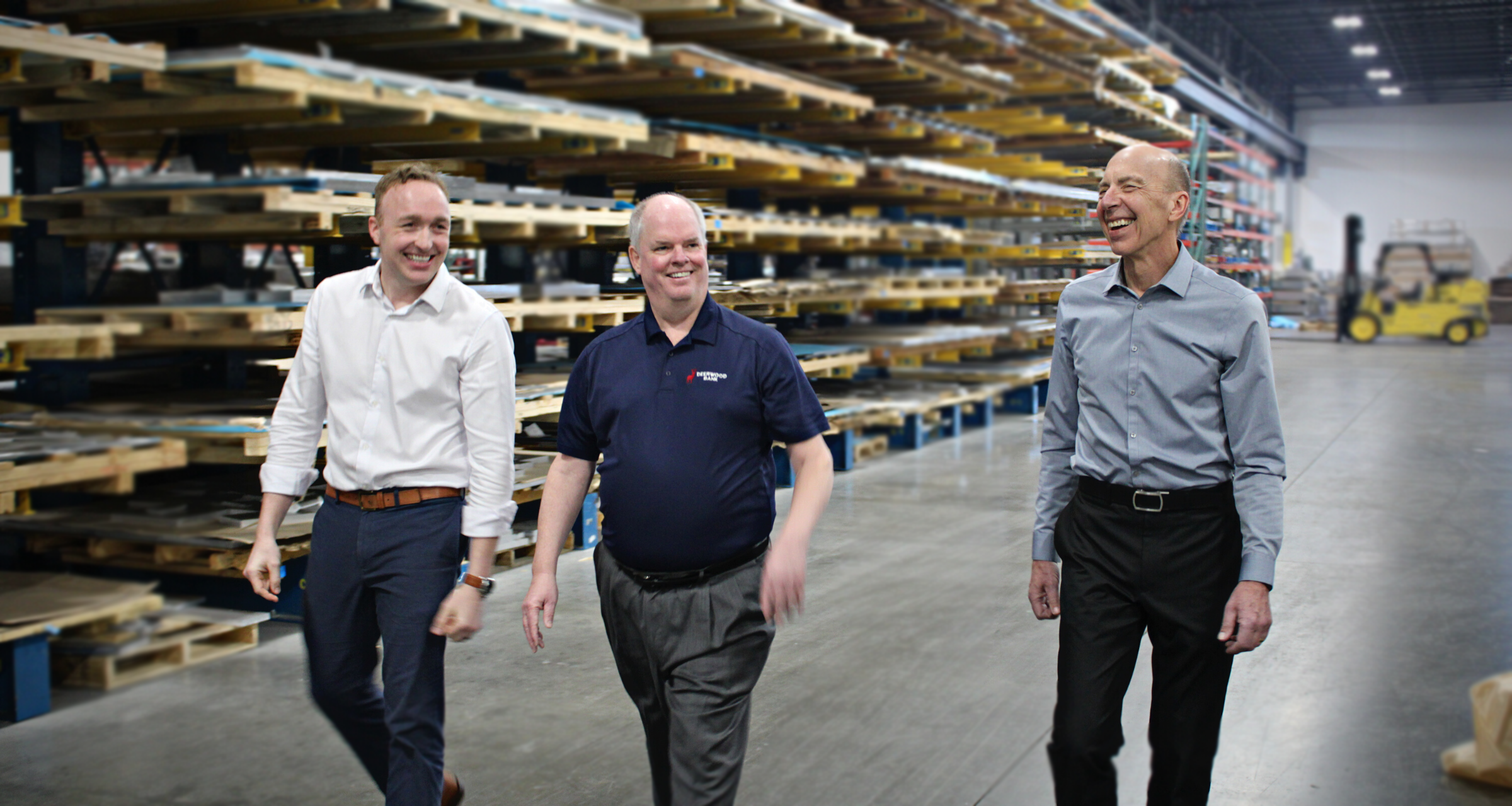 people walking through a business warehouse laughing